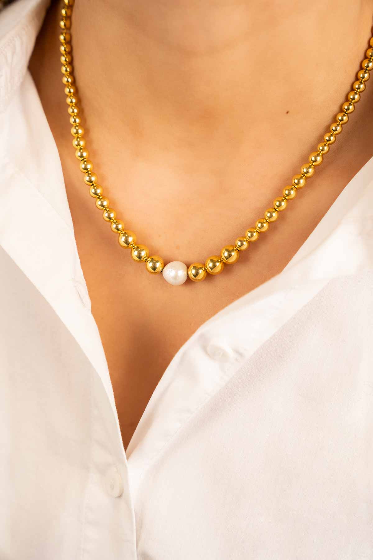 Gold color necklace with a cannonball with pearl Lilaclott-theme.productDescriptionPage.SEO.byTheBrand